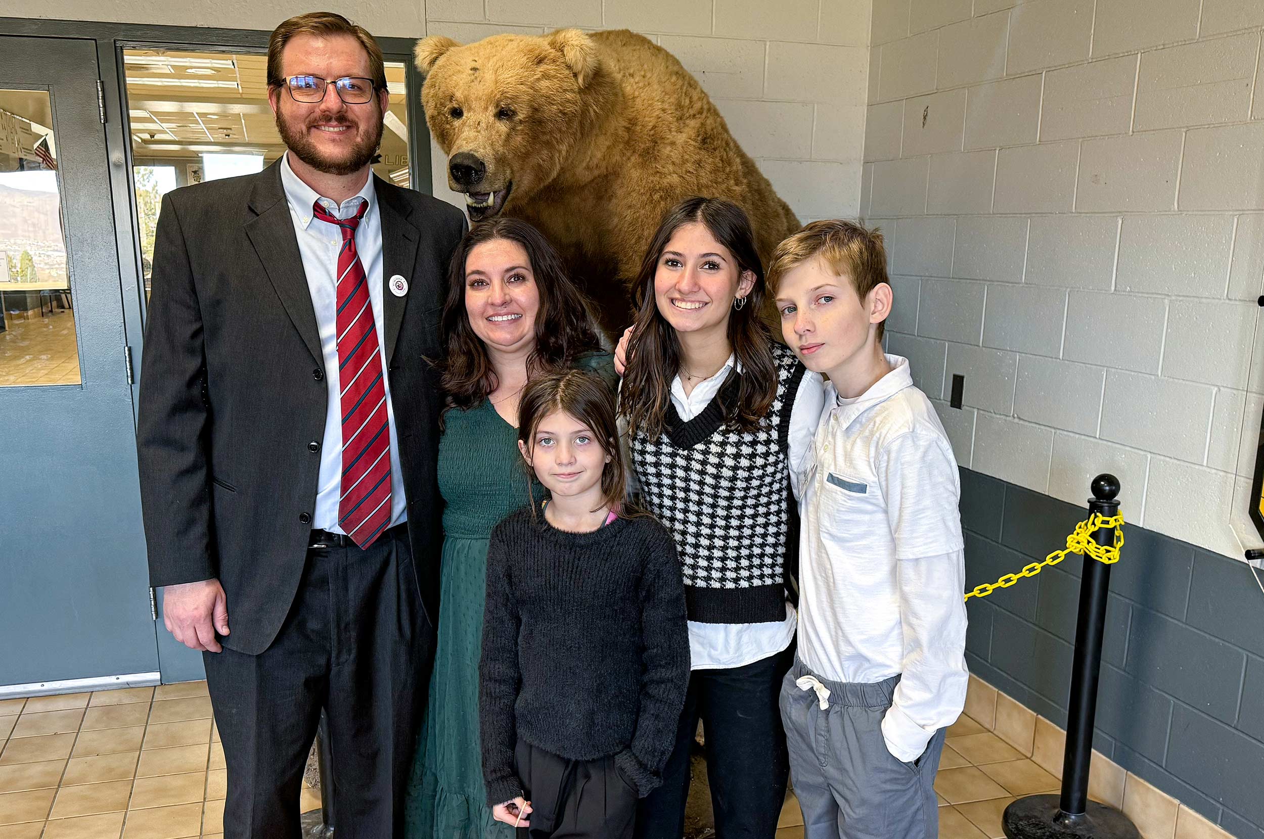 Christine Hull and her family at the entrance to Galena High School